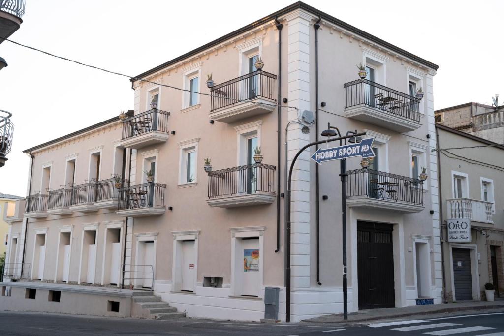 克罗夏Antico Palazzo del Corso的带阳台和街标的大型白色建筑