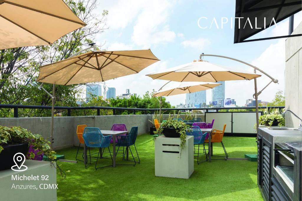 墨西哥城Capitalia - Apartments - Anzures的一个带桌椅和遮阳伞的庭院