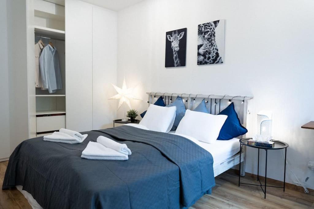 布尔诺Central Park Apartments的卧室配有蓝色和白色的床,提供毛巾