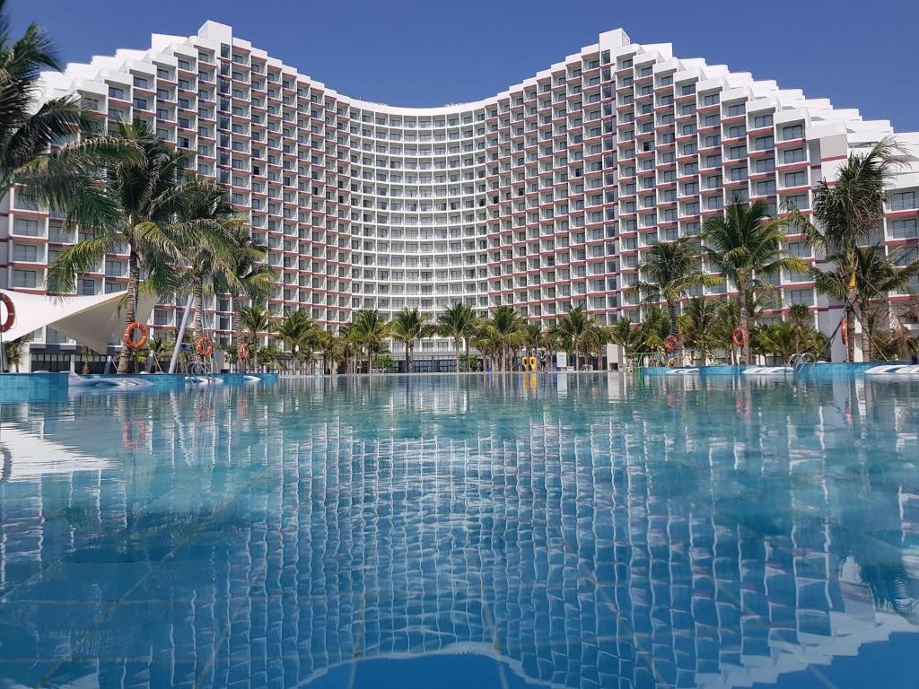 Miếu ÔngThe Arena Cam Ranh Resort all Luxury Service的一座大型度假建筑,设有大型游泳池