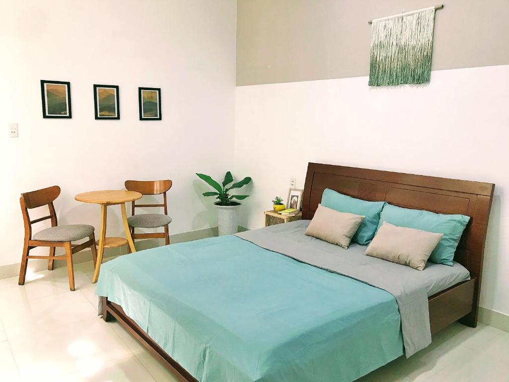 Kinh DinhNạp Homestay的卧室配有一张床和一张桌子及椅子