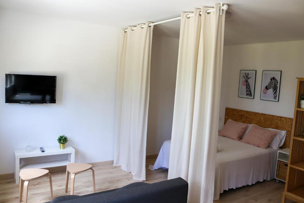 格罗韦Casal Do Crego的一间卧室配有白色窗帘的床