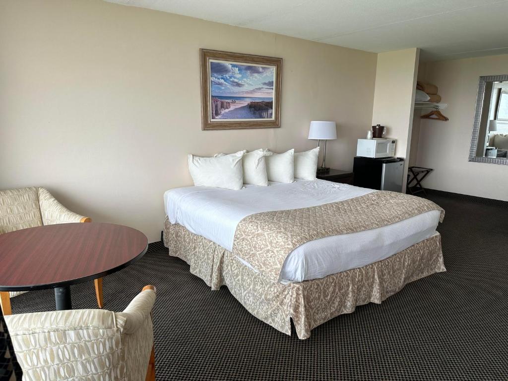 威尔伍德克拉斯特Diamond Crest Motel的酒店客房设有一张大床和一张桌子。