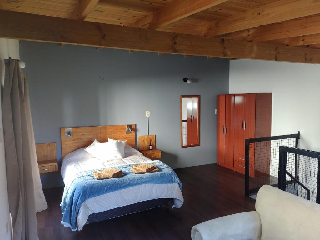 本塔纳山村Departamentos Ventana的一间卧室设有一张床和木制天花板
