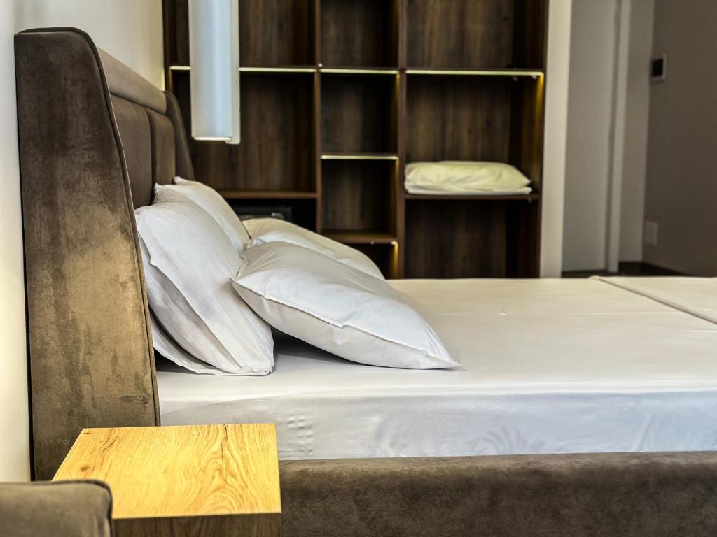 都拉斯ALEXANDER Rooms & Apartments的床上铺有白色枕头的床