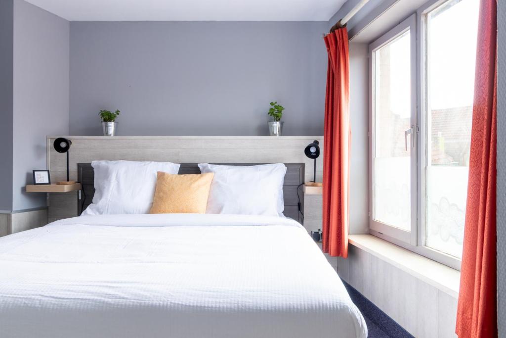 布鲁日Entree的卧室配有白色的床和窗户。