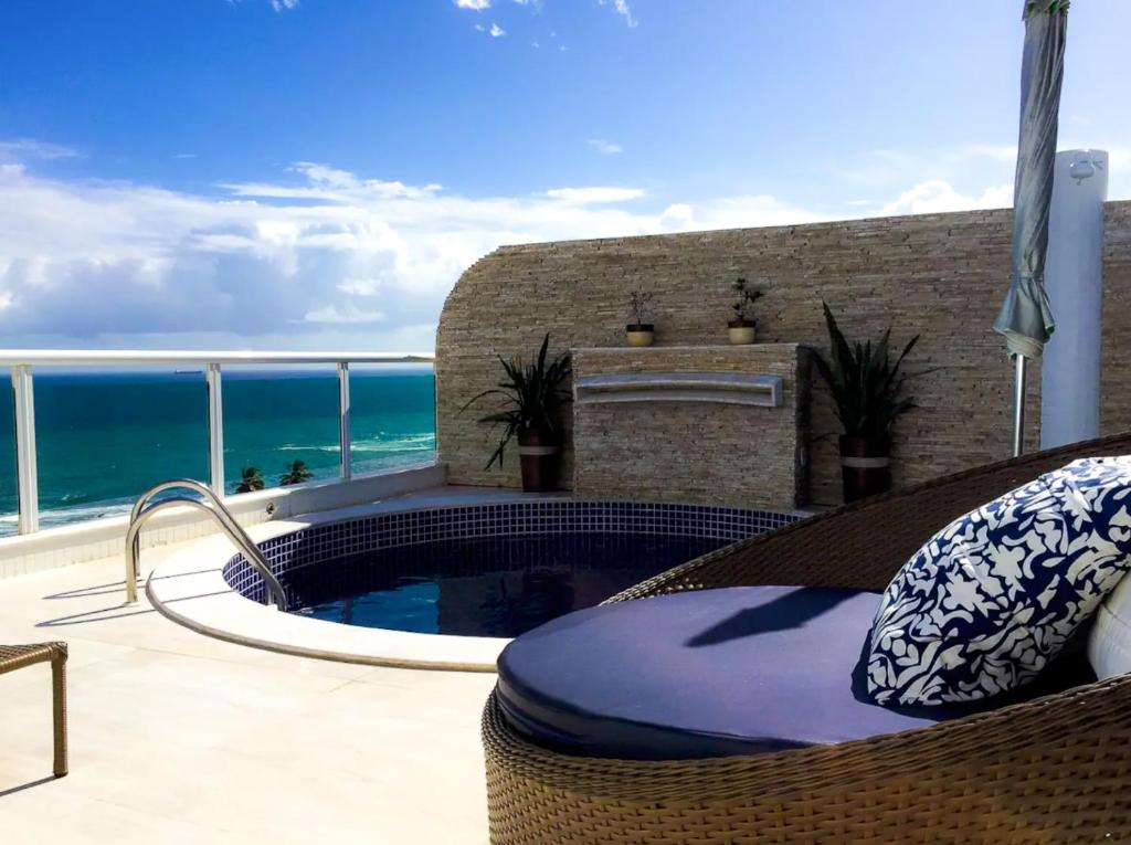 萨尔瓦多Apartamento-Cobertura de Luxo Vista Mar em Salvador的一个带游泳池和海洋的庭院