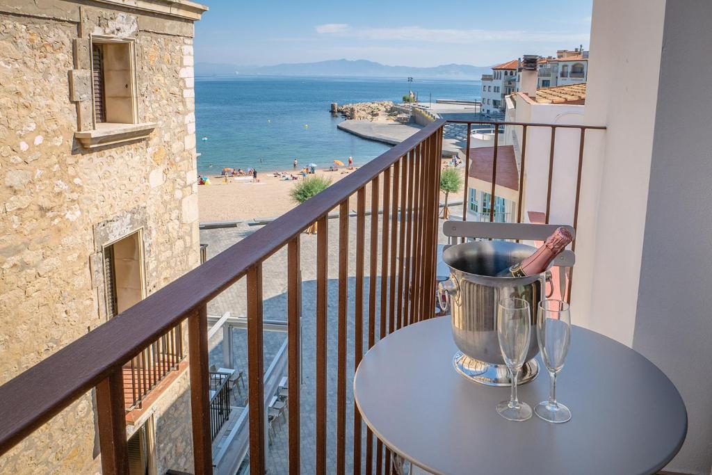 莱斯卡拉Taverna de la Sal Boutique Hotel的海景阳台上配有水桶的桌子