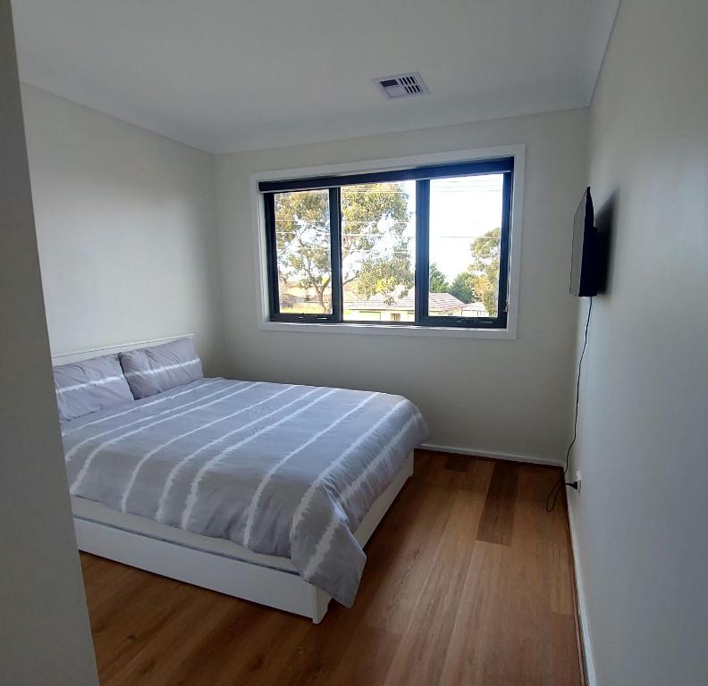 墨尔本Maruve Guesthouse 12 min from Melb airport的白色的卧室设有床和窗户