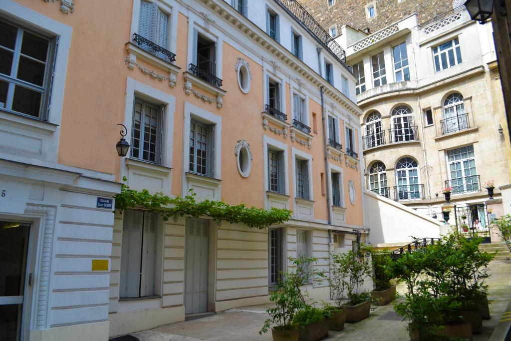 巴黎Le M. Musée du vin - l'appartement的一条有植物的街道上的一排建筑物