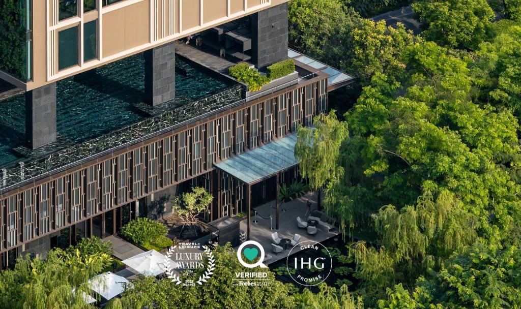 曼谷曼谷金普顿玫兰酒店 - an IHG Hotel的享有带游泳池的大楼的顶部景致