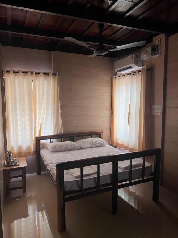 乌杜皮Eesha Residency的一间带床的卧室,位于带窗帘的房间