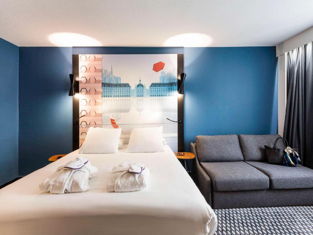 波尔多Mercure Bordeaux Centre Ville的酒店客房,配有床和沙发