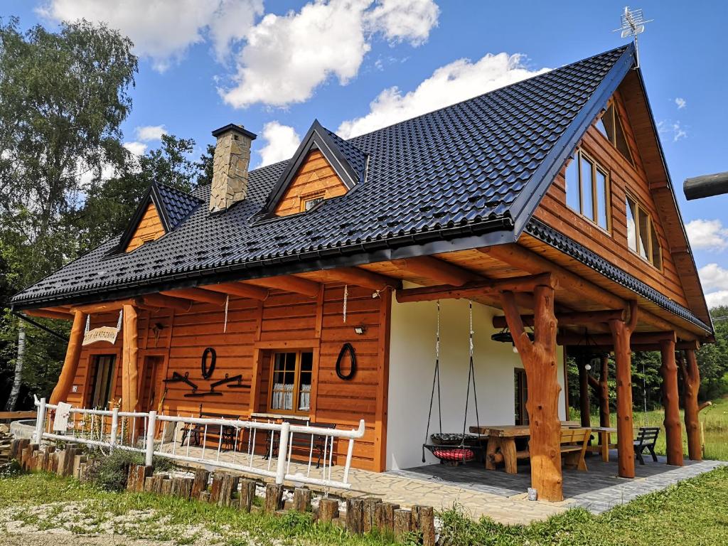 Dom Na Korzeniu的小木屋,设有黑色屋顶