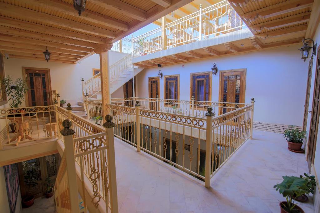 布哈拉Xadijam Hotel的一条空洞的走廊,有木楼梯