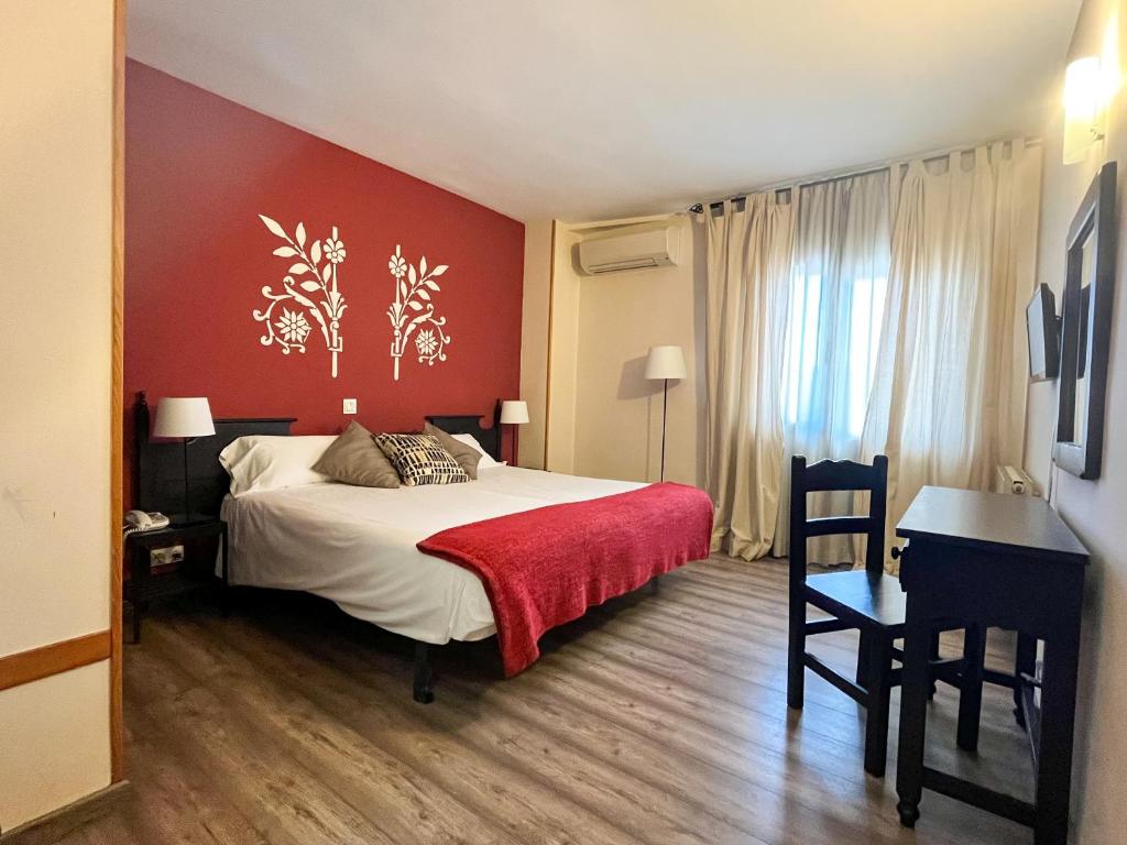 拉拉斯特里拉文塔玛谷罗酒店的一间卧室设有一张床和红色的墙壁