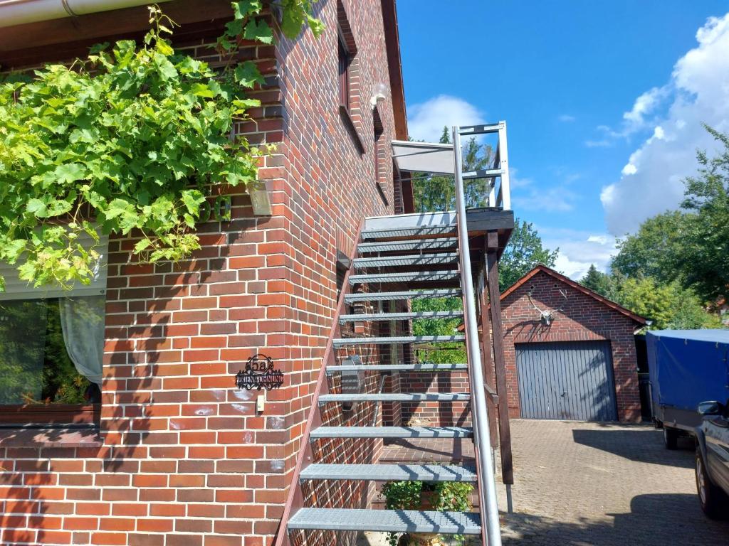 施内沃丁根Wruck,Ferienwohnung的靠在建筑物旁边的砖墙上的梯子