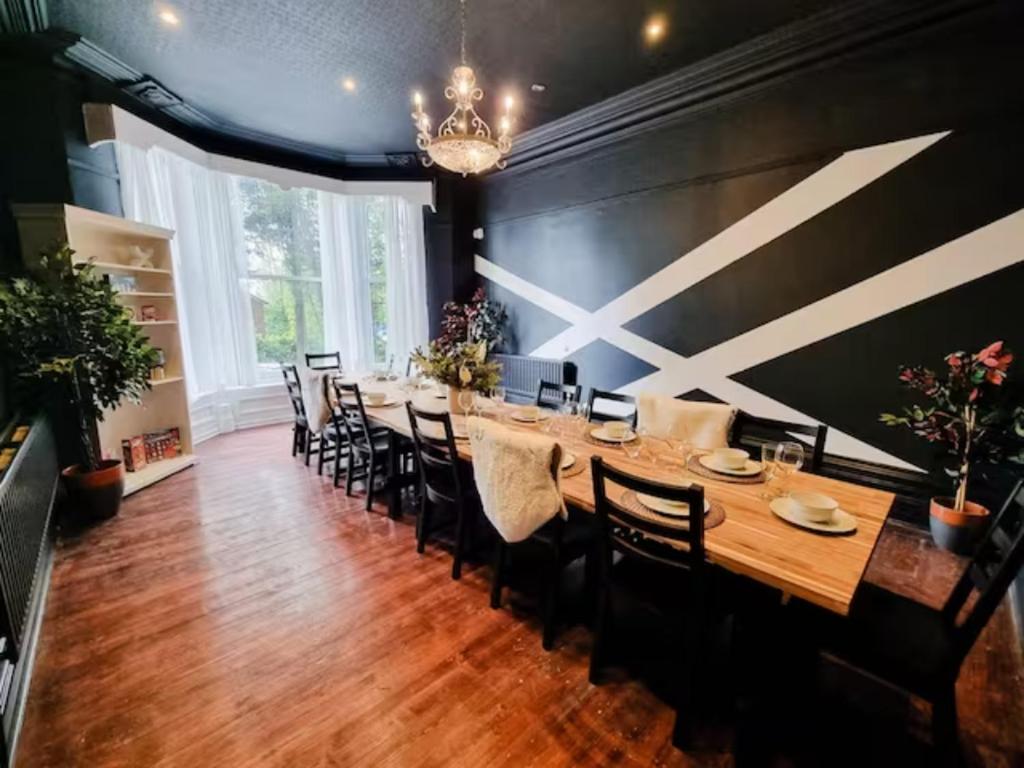 阿什顿下安林恩Sleeps 20 Stunning Ashton Mansion的大型用餐室配有长桌和椅子
