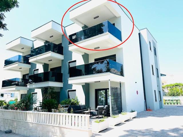 奥瑞比克Apartment Marta的一座白色的大建筑,上面有红圆