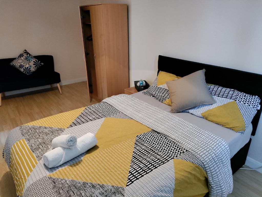 诺斯伍德Beautiful House in Ruislip的一间卧室配有一张大床和毛巾