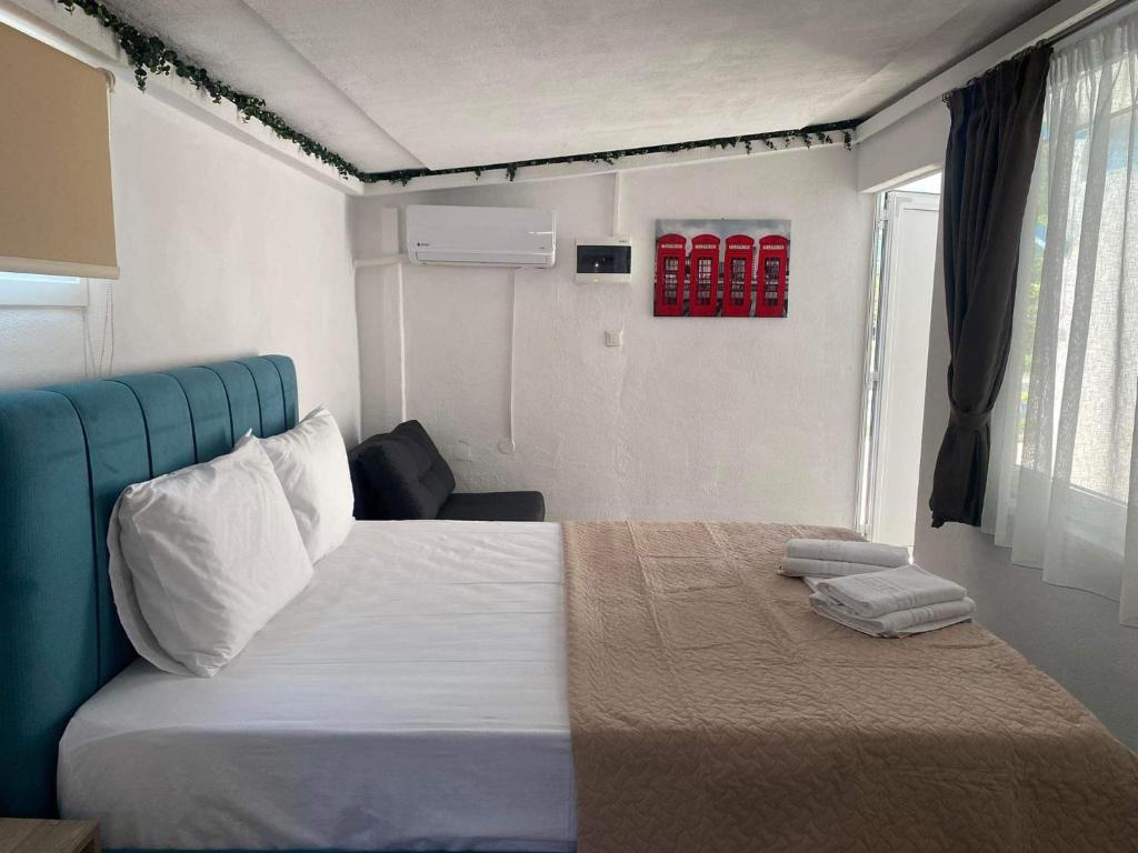 克里斯阿穆迪亚STUDIOS TASOS BI的一间卧室配有一张大床和蓝色床头板