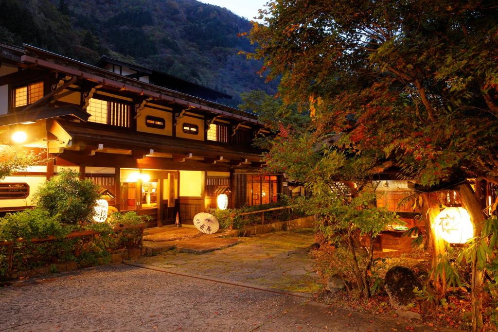 高山汤本朝哉日式旅馆的一座日本房子前面有灯