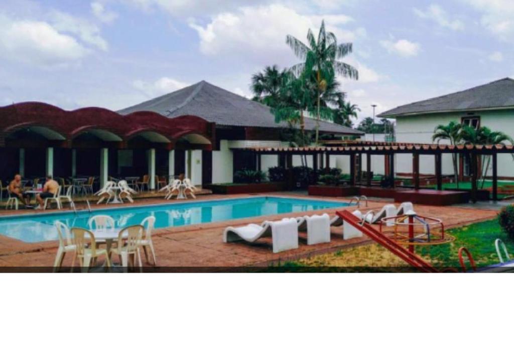 贝伦维拉黎加贝伦酒店的一个带桌椅的游泳池的度假酒店