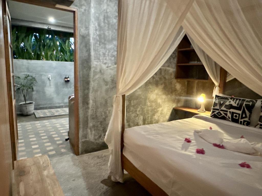 班尤温当Mangroove Bay Boutique Hostel的一间卧室配有一张床,浴室设有淋浴。