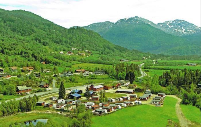 VossestrandMidttun Camping og Feriehytter的山谷中的一个小村庄,有山