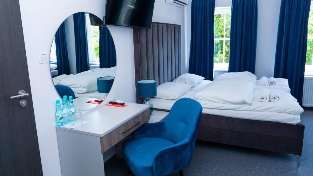 布热格Bon Żur的酒店客房,配有一张床和一张蓝色椅子