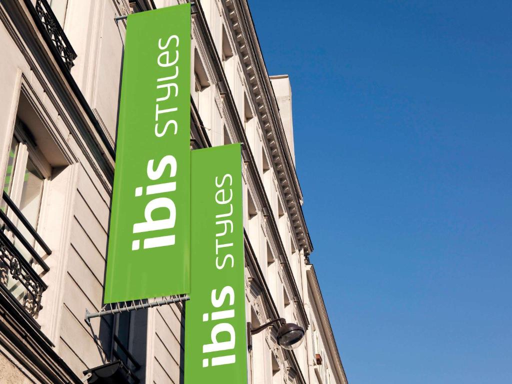 巴黎ibis Styles Paris République Le Marais的建筑物一侧的绿色标志