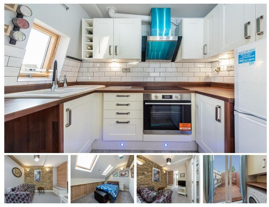 伦敦Newly Refurb Period 1-Bed Apartment with Roof Terrace, 47 sqm-500 sqft, in Putney near River Thames的厨房配有白色橱柜和炉灶烤箱。