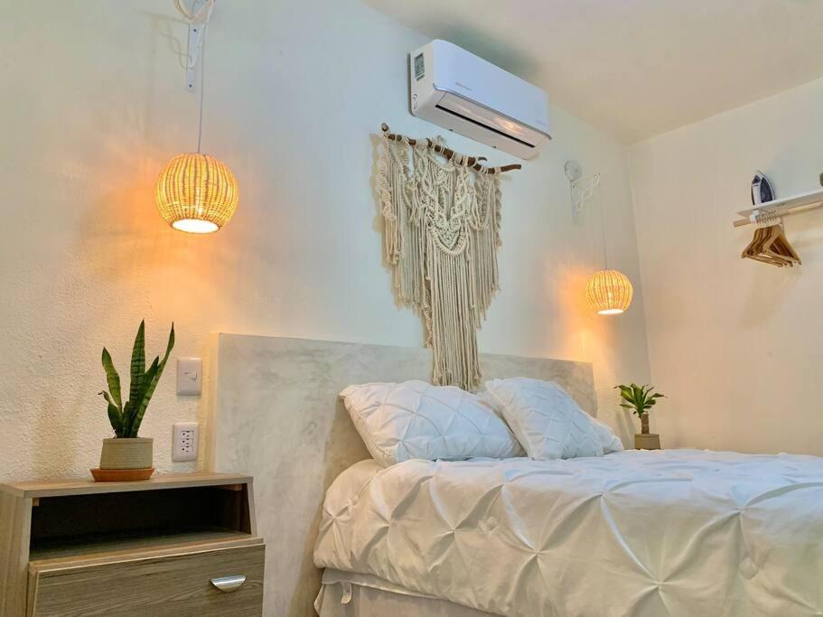 圣何塞德尔卡沃Casa Añuiti céntrica ubicación.的一间卧室配有一张带风扇和灯的床。