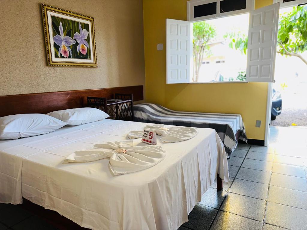 阿拉卡茹蒲莎达阿卡兰托酒店的酒店客房,配有两张带白色床单的床