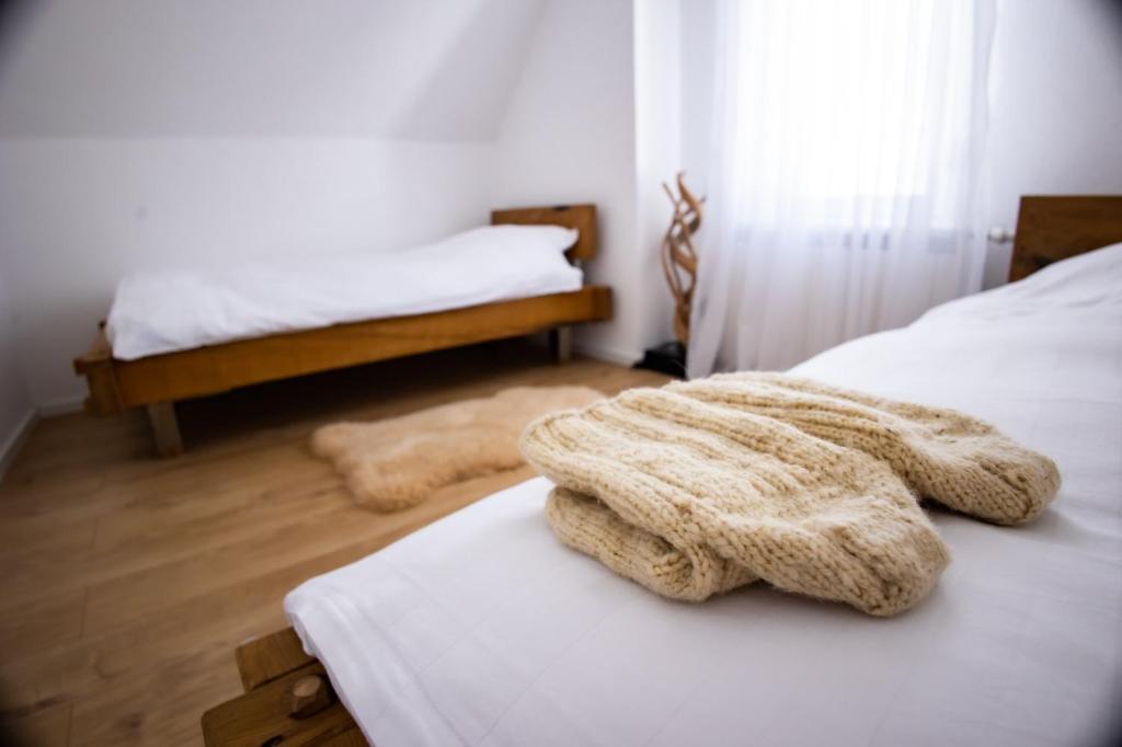 新帕扎尔Topli kutak Golija的一间卧室配有两张带白色床单的床