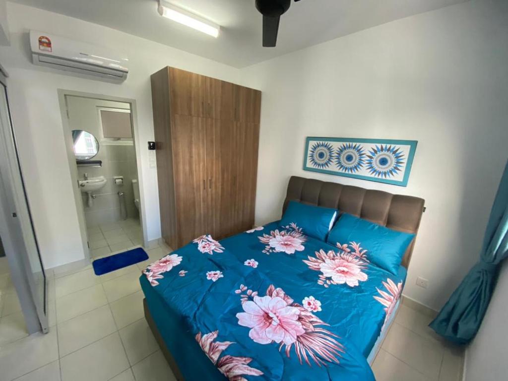 雪邦KLIA KLIA2 Alanis Sepang Putrajaya Cyberjaya Nilai by 3SIBS的一间卧室配有一张带鲜花的蓝色床