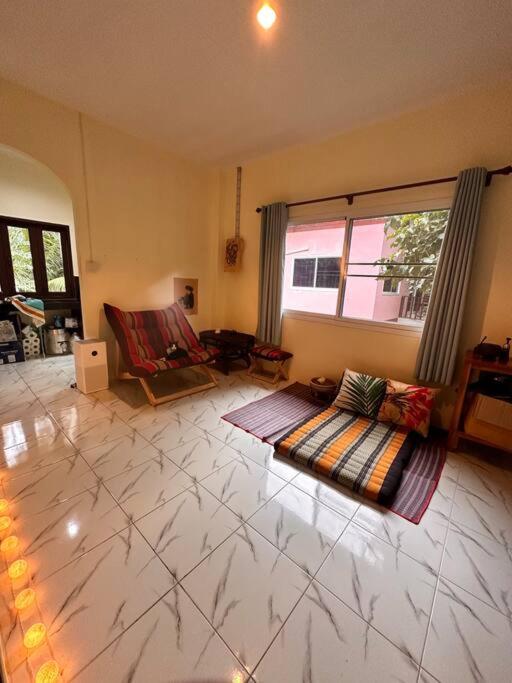 Ban NuaCozy Garden House in Kohphangan!的一间客厅,地板上铺有地毯