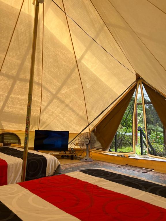 丹那拉打The Backyard Glamping Cameron Highlands的一间卧室配有带两张床的帐篷