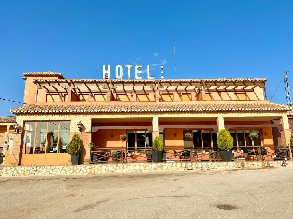 格拉纳达省阿拉马卡诺斯阿尔采瑟餐厅酒店 的一座酒店大楼,上面有标志