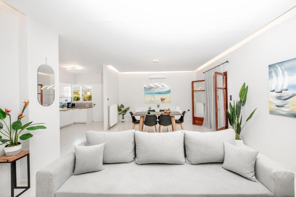 基萨莫斯Villa Katrin的带沙发的白色客厅和用餐室