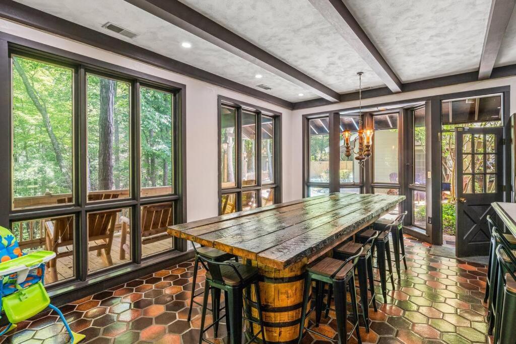 加特林堡Bourbon Hollow Lodge with Hot Tub and Pool plus Game Room only 5 min to downtown的一间有大木桌和椅子的餐厅