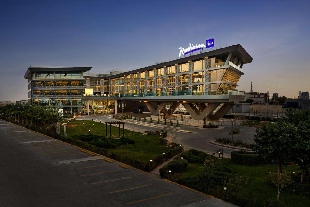 利雅德Radisson Blu Hotel Riyadh Convention and Exhibition Center的一座大建筑,上面有标志