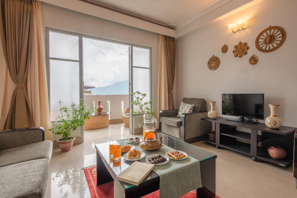 甘托克StayVista's Mystic Nest - Mountain & Valley-View Apartment with Contemporary Interiors & Modern Amenities的客厅配有沙发和桌子