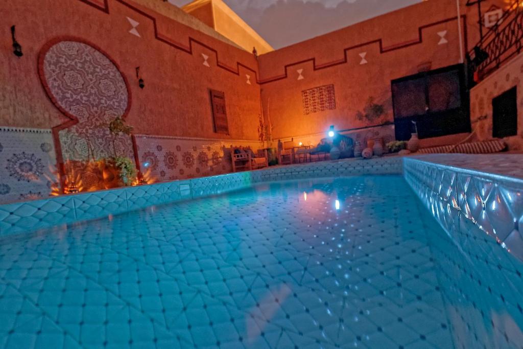 瓦尔扎扎特Riad Parfums de OUARZAZATE的一座大楼内的大型游泳池