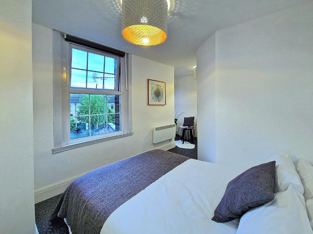 伦敦Charming room in Central London的卧室配有白色的床和窗户。