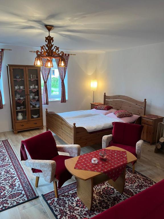 Chalupa Františkov的卧室配有一张床和一张桌子及椅子