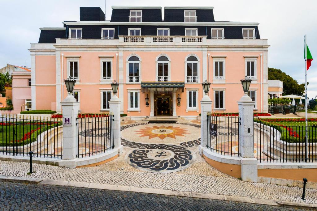里斯本奥利斯拉帕帕里斯酒店 - 世界顶级酒店的一座大型粉红色房子,前面有一个门