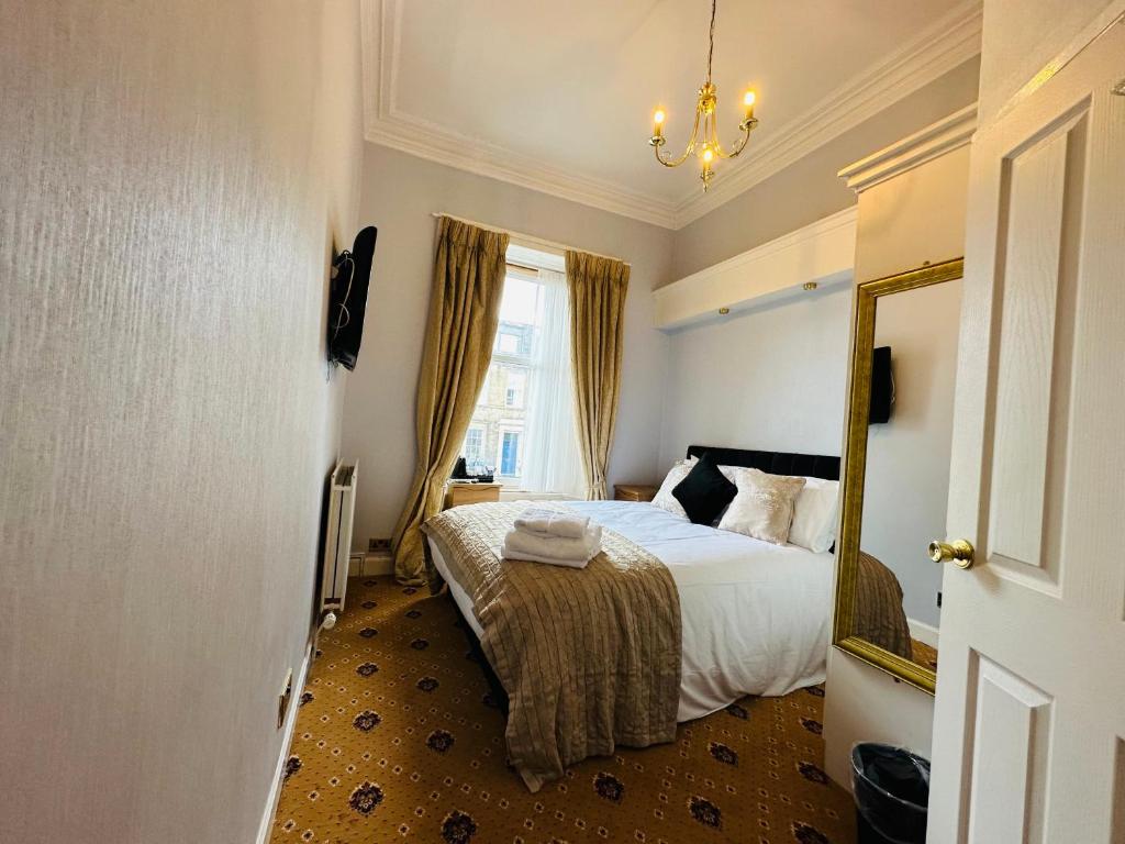 爱丁堡阿博茨福德宾馆的酒店客房,配有床和镜子