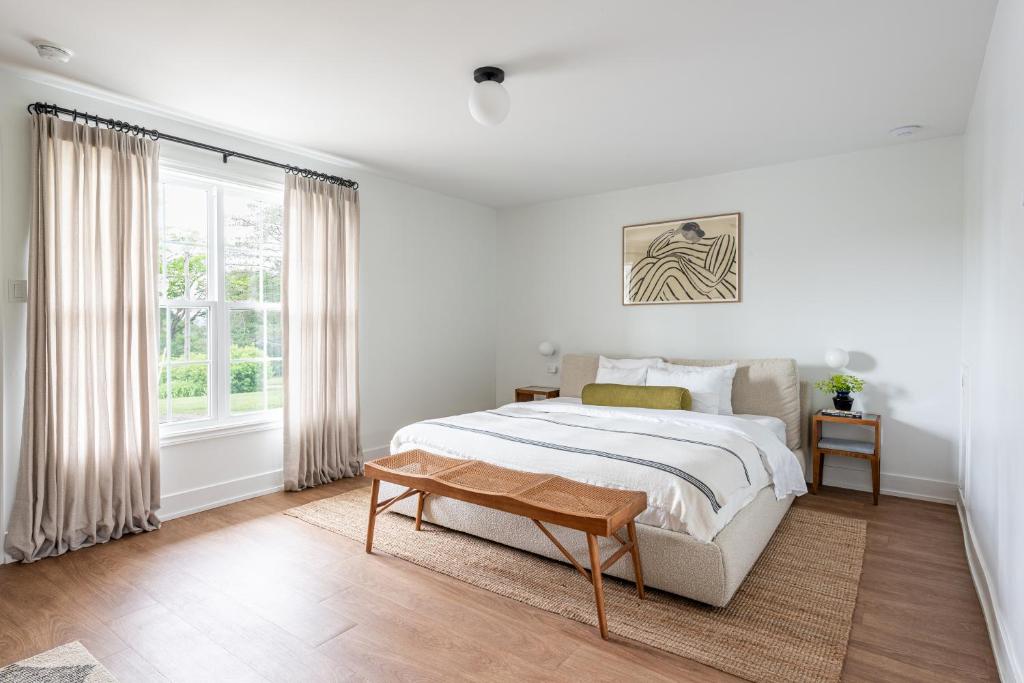 Grand préEvangeline的白色的卧室设有床和窗户