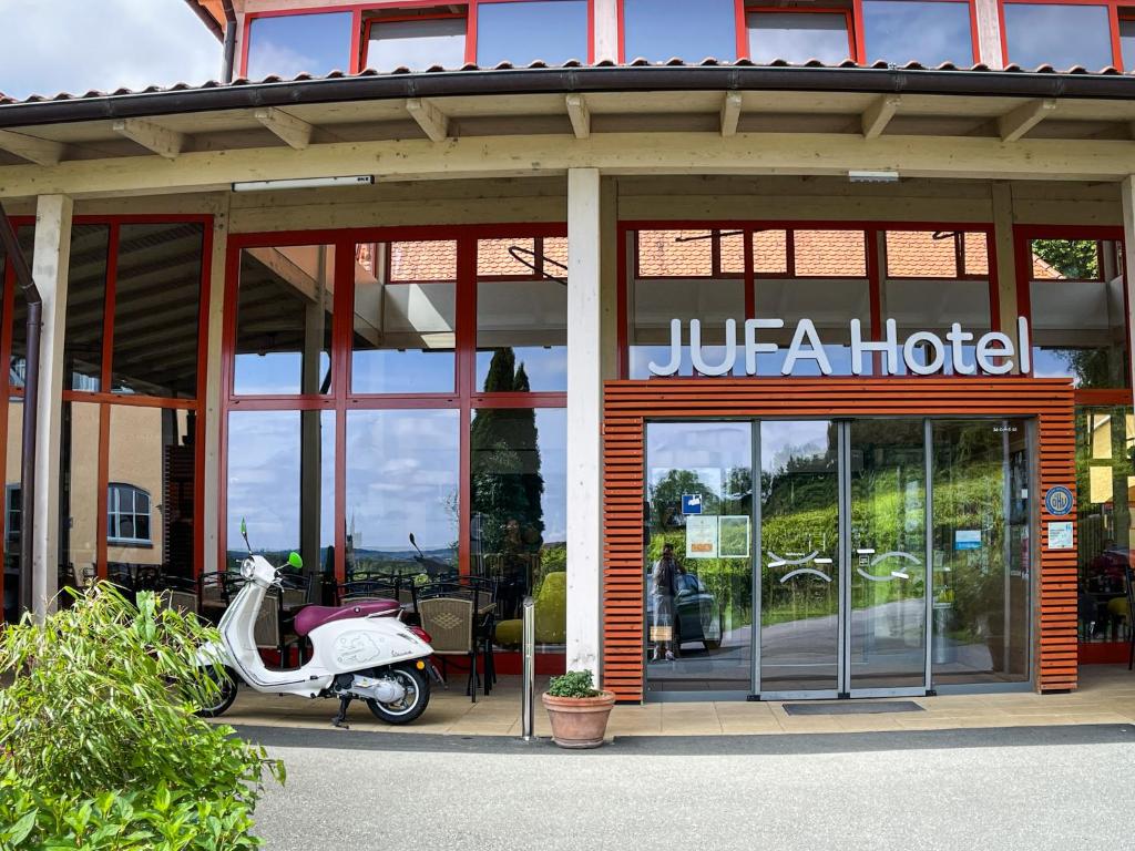 德意志兰茨贝格JUFA Hotel Deutschlandsberg的停在酒店外的摩托车